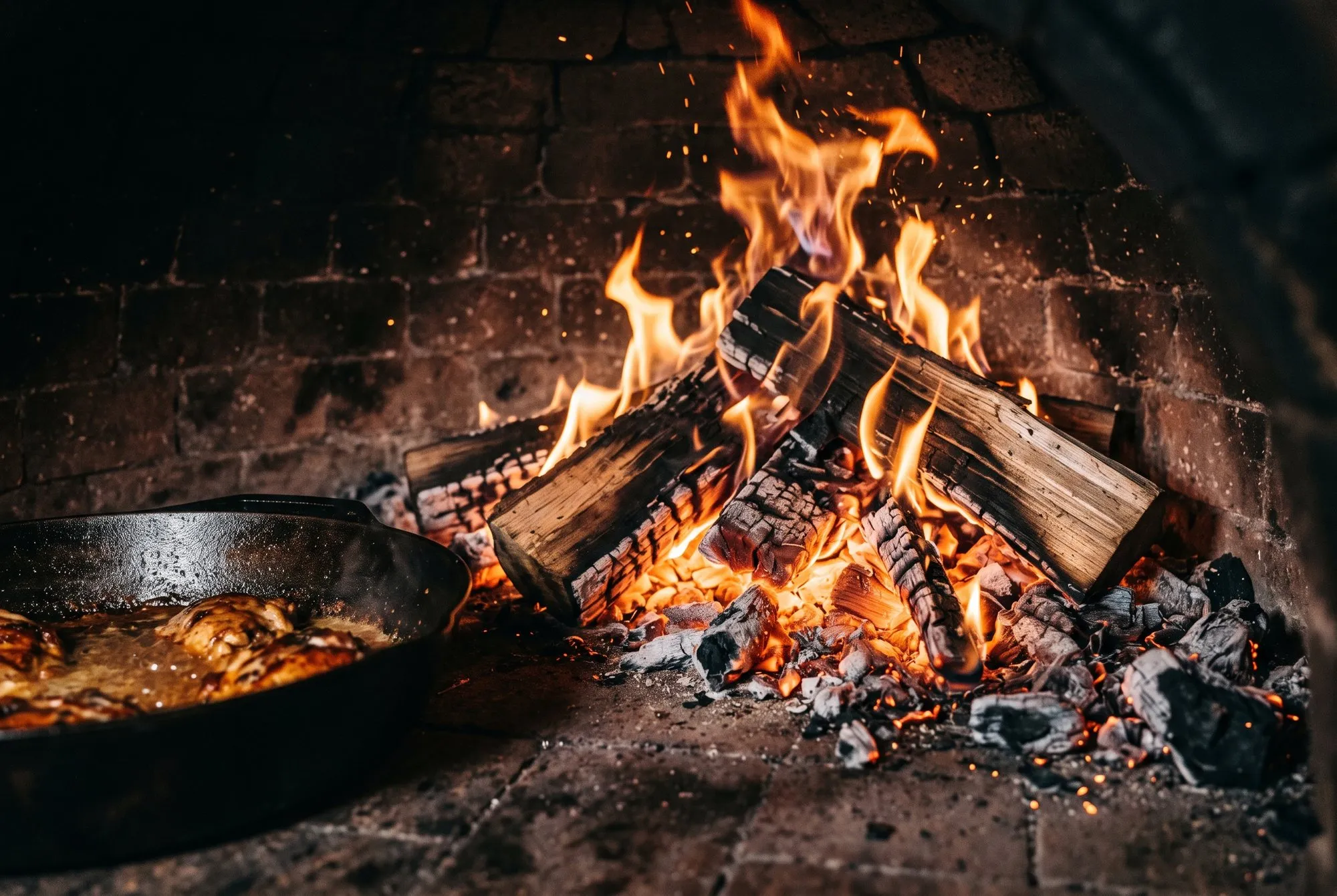 Flames and embers inside the wood-fired oven